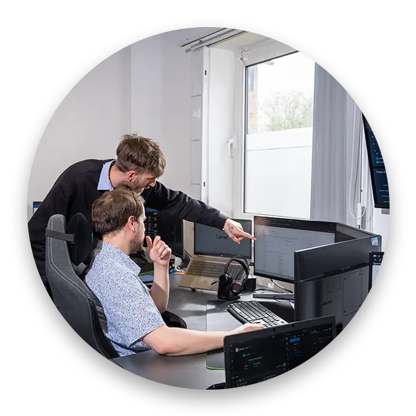 CIpher IT team pointing at a monitor helping with IT Support