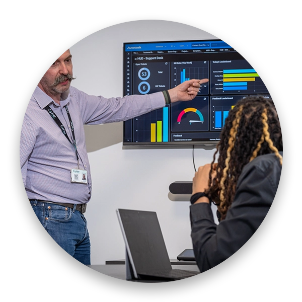 Cipher-IT-team-in-a-meeting-room-looking-at-statistics