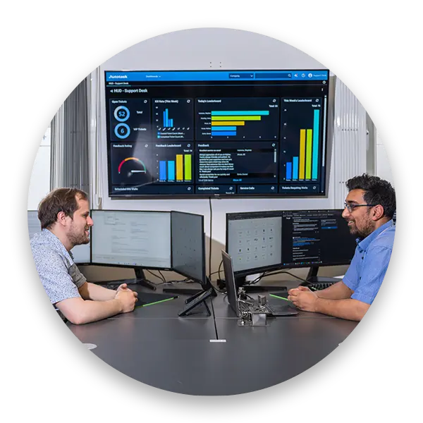 Cipher IT team working together in the office at shared desk